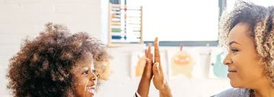 Teacher playing with child in a classroom