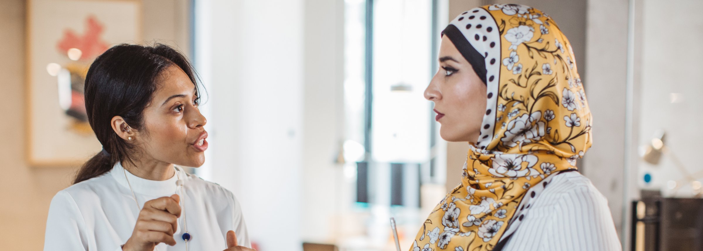 two woman talking in a classroom